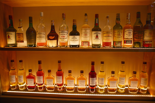 Alcohol bottles behind a bar.